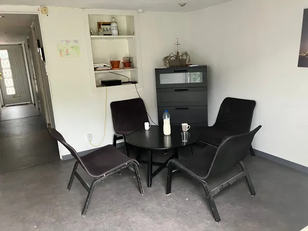 The shared lounge with armchairs and coffee table